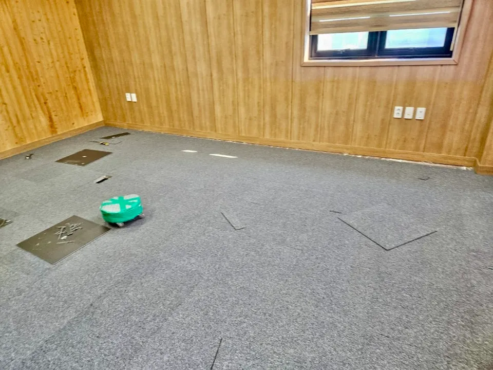 임원실 바닥에 카펫타일을 붙여 나가는 중간 모습